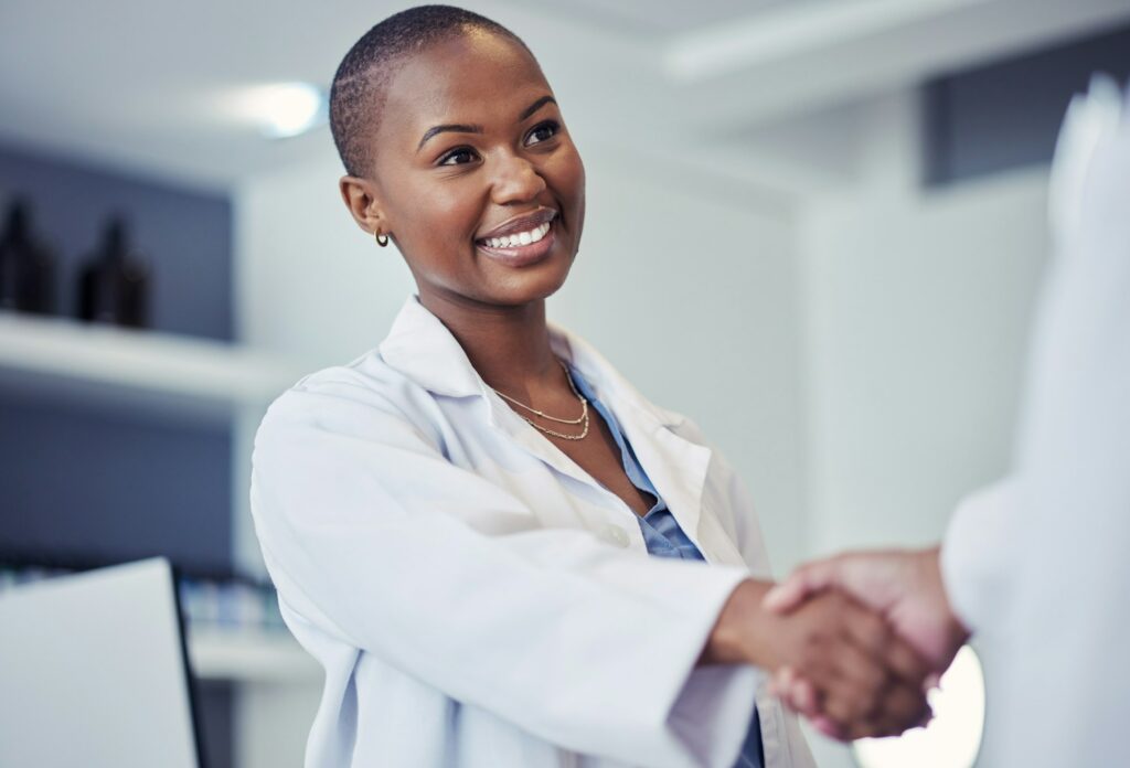 Black woman, scientist and handshake, smile for partnership and science collaboration with introduc
