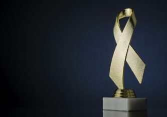 Symbolic textured gold ribbon trophy award